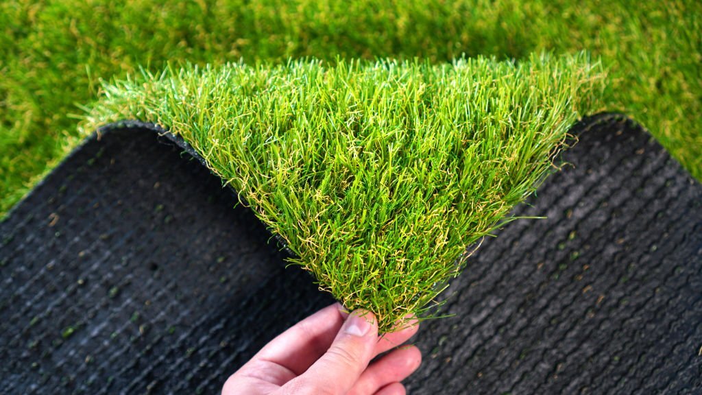 how is synthetic grass application made in football fields